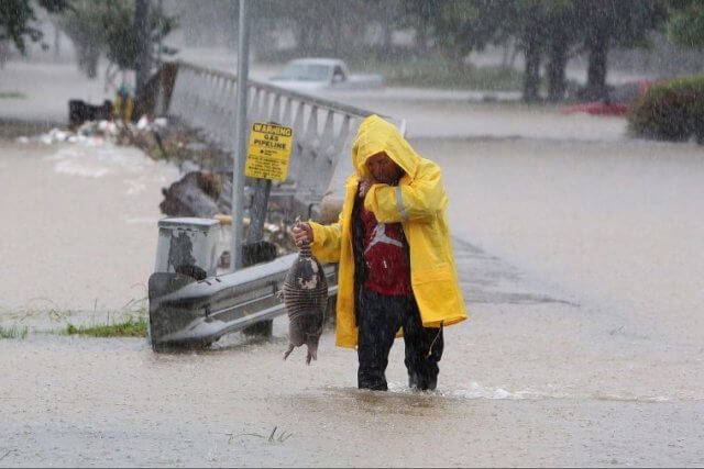 man standing in water after a serious flood 