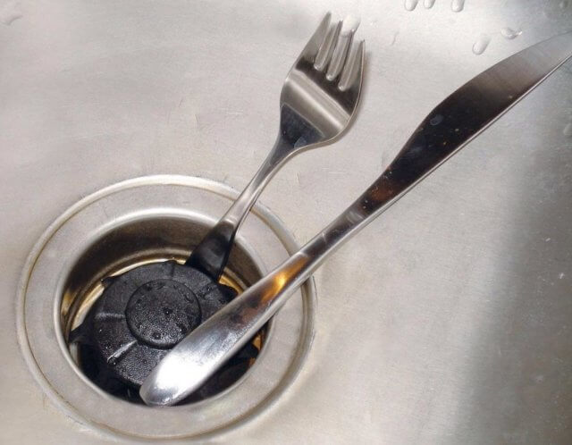 objects such as broken glass, a fork, or a spoon can cause why your garbage disposal is stuck