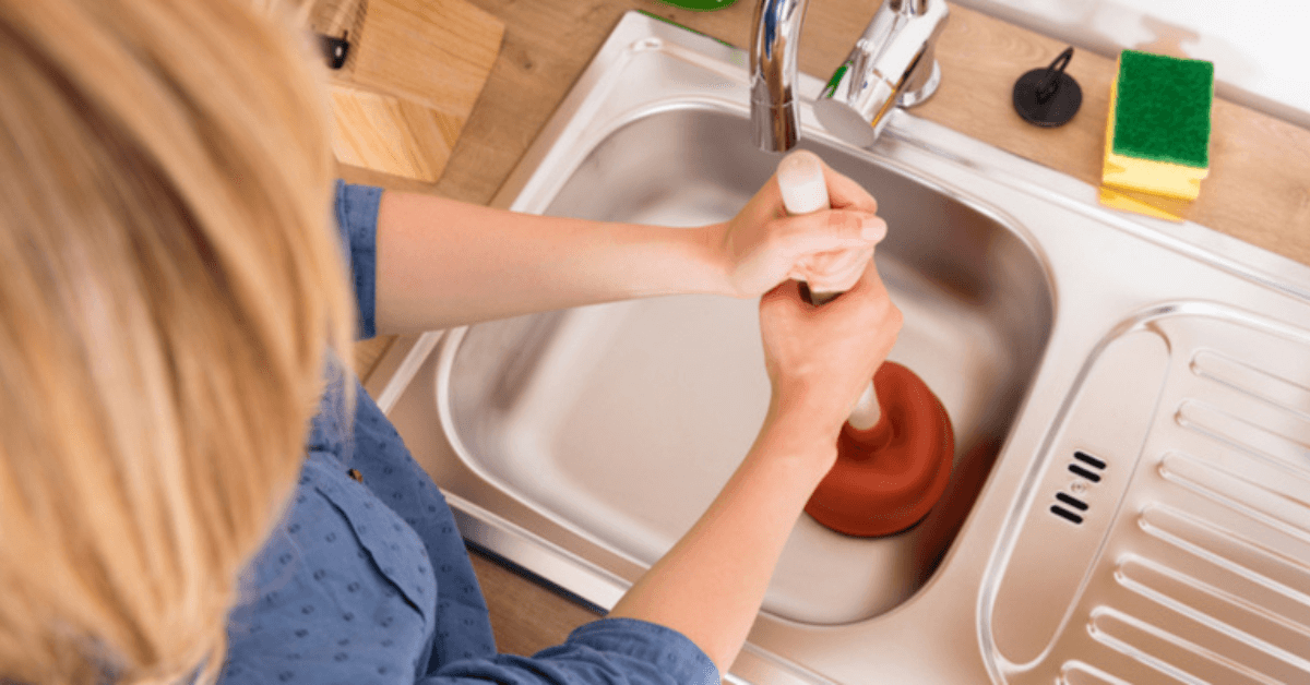 plunging the kitchen sink to unclog the drain